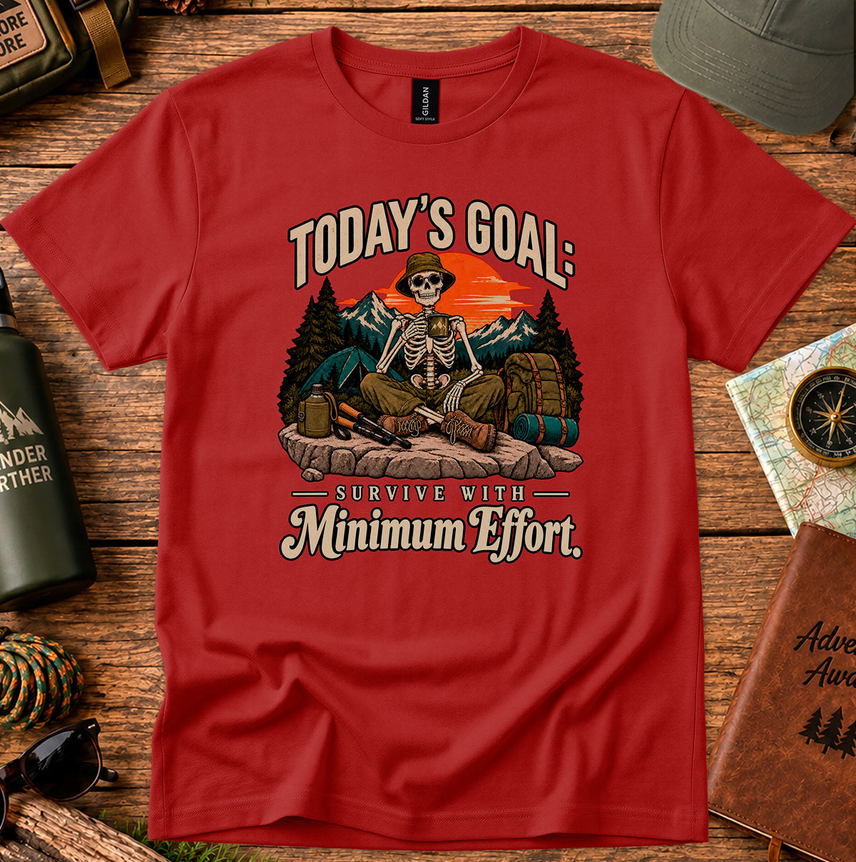 Today's Goal Minimum Effort T-shirt with a seated skeleton camper, tent, backpack, mountains and sunset
