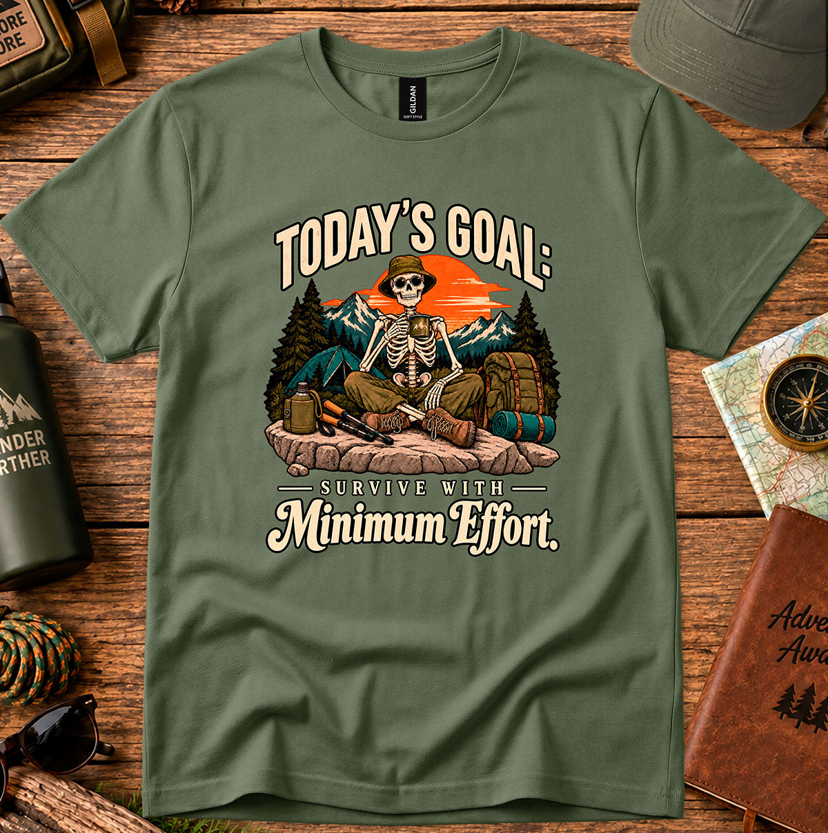 Today's Goal Minimum Effort T-shirt with a seated skeleton camper, tent, backpack, mountains and sunset