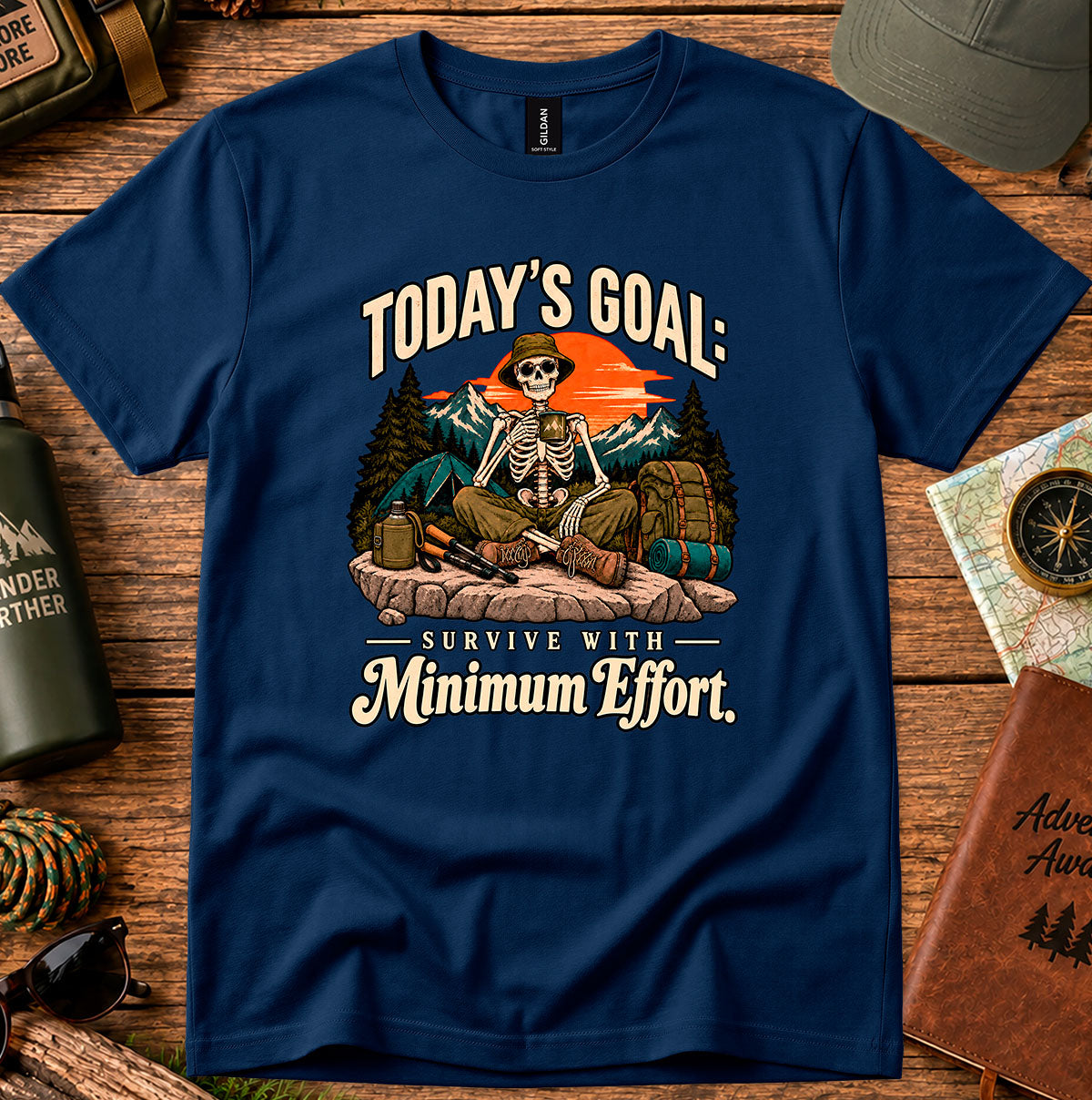 Today's Goal Minimum Effort T-shirt with a seated skeleton camper, tent, backpack, mountains and sunset
