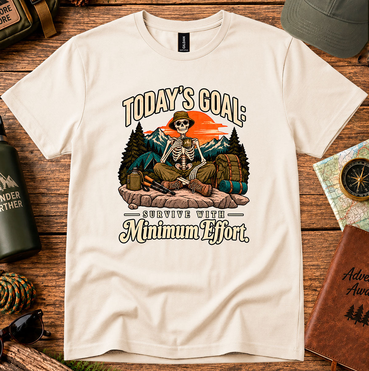 Today's Goal Minimum Effort T-shirt with a seated skeleton camper, tent, backpack, mountains and sunset