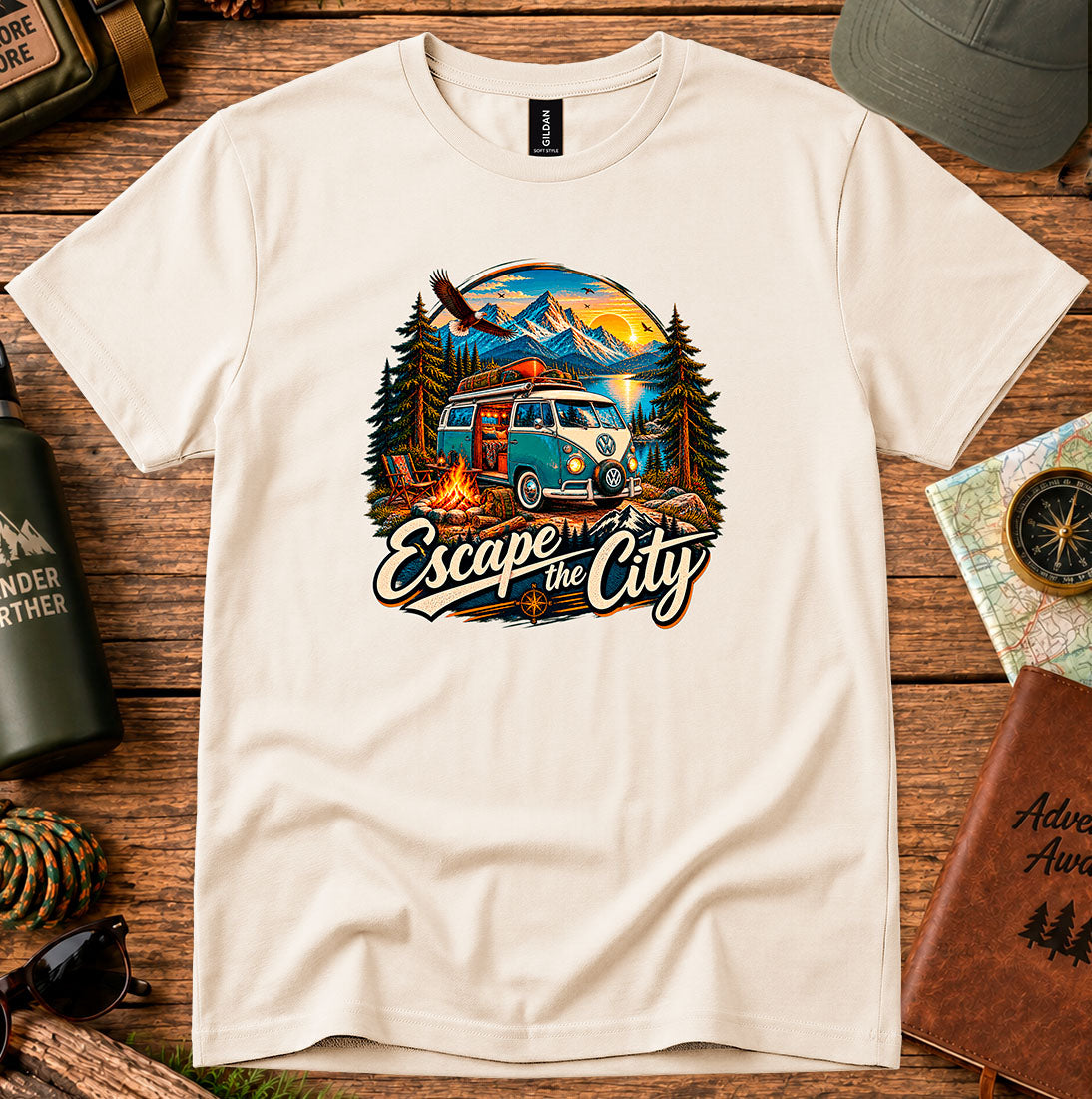 T-shirt featuring a retro camper by a mountain lake and glowing campfire