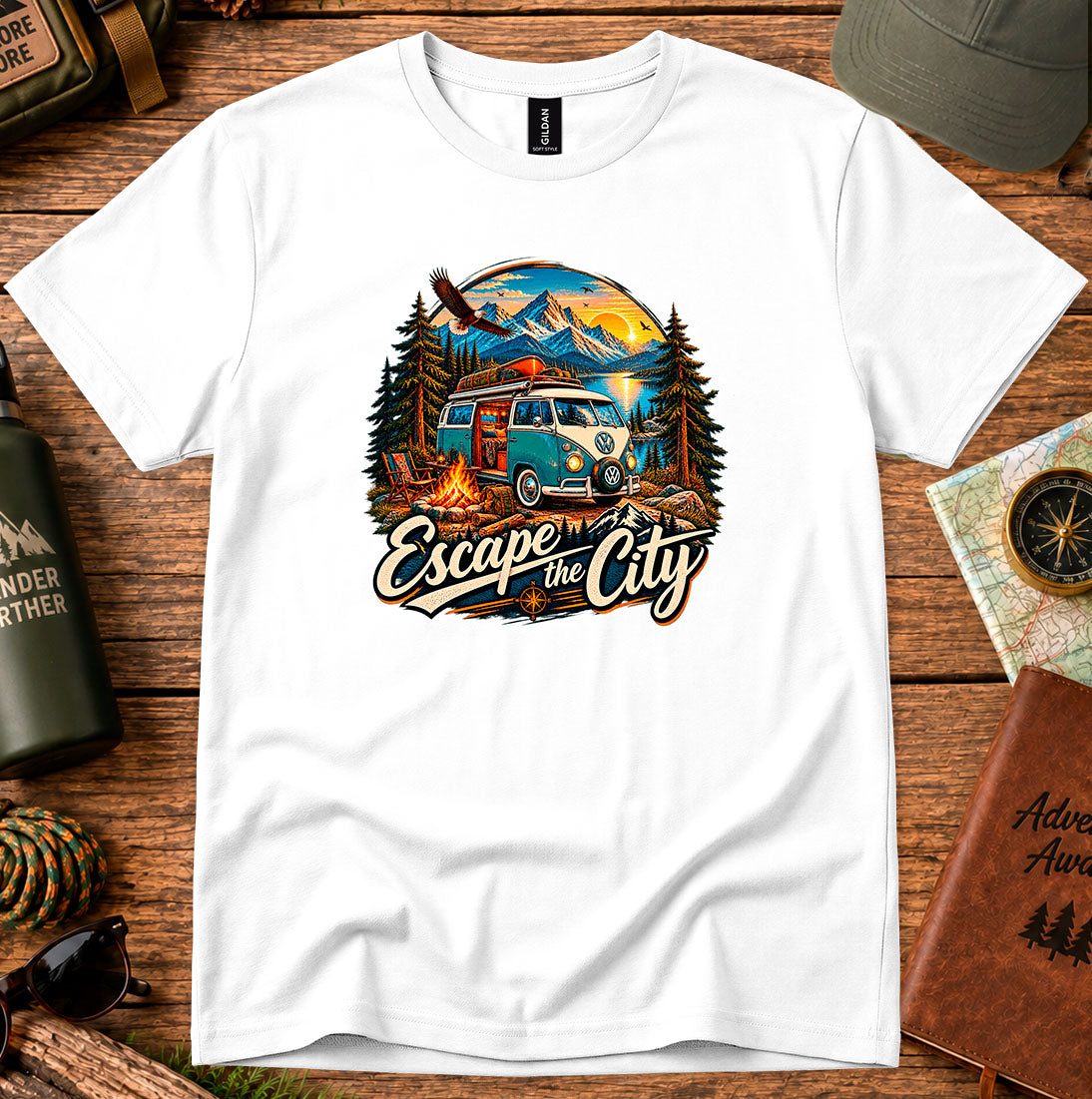 T-shirt featuring a retro camper by a mountain lake and glowing campfire