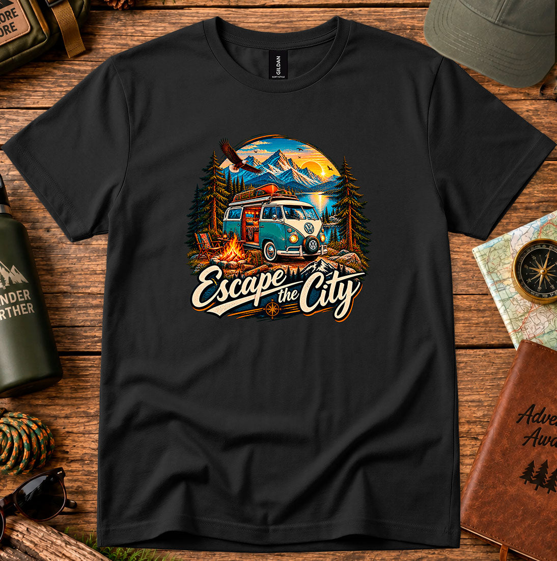 T-shirt featuring a retro camper by a mountain lake and glowing campfire