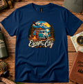 T-shirt featuring a retro camper by a mountain lake and glowing campfire