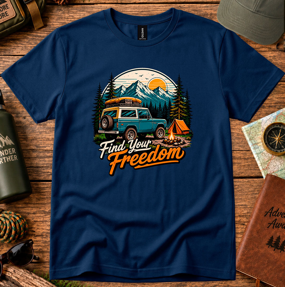 T-shirt featuring a vintage camper and campfire beneath a mountain sunset