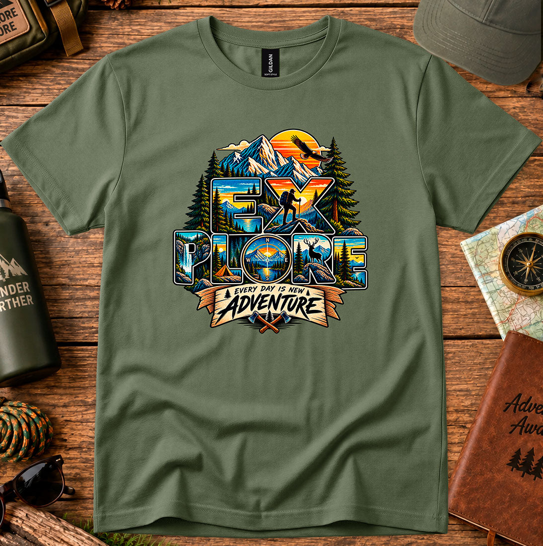T-shirt featuring mountains, sunset colors and pine silhouettes inside bold lettering