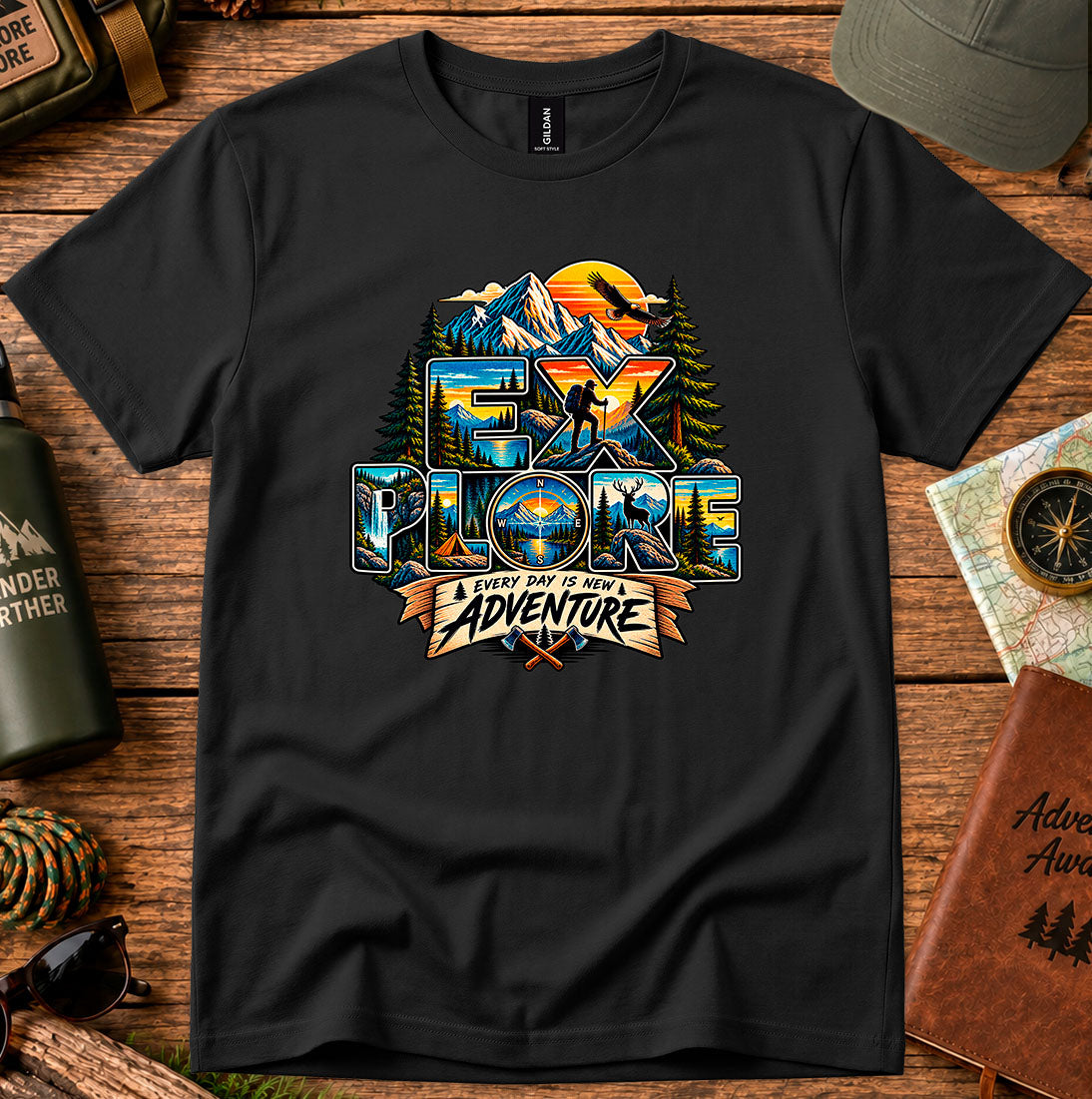 T-shirt featuring mountains, sunset colors and pine silhouettes inside bold lettering