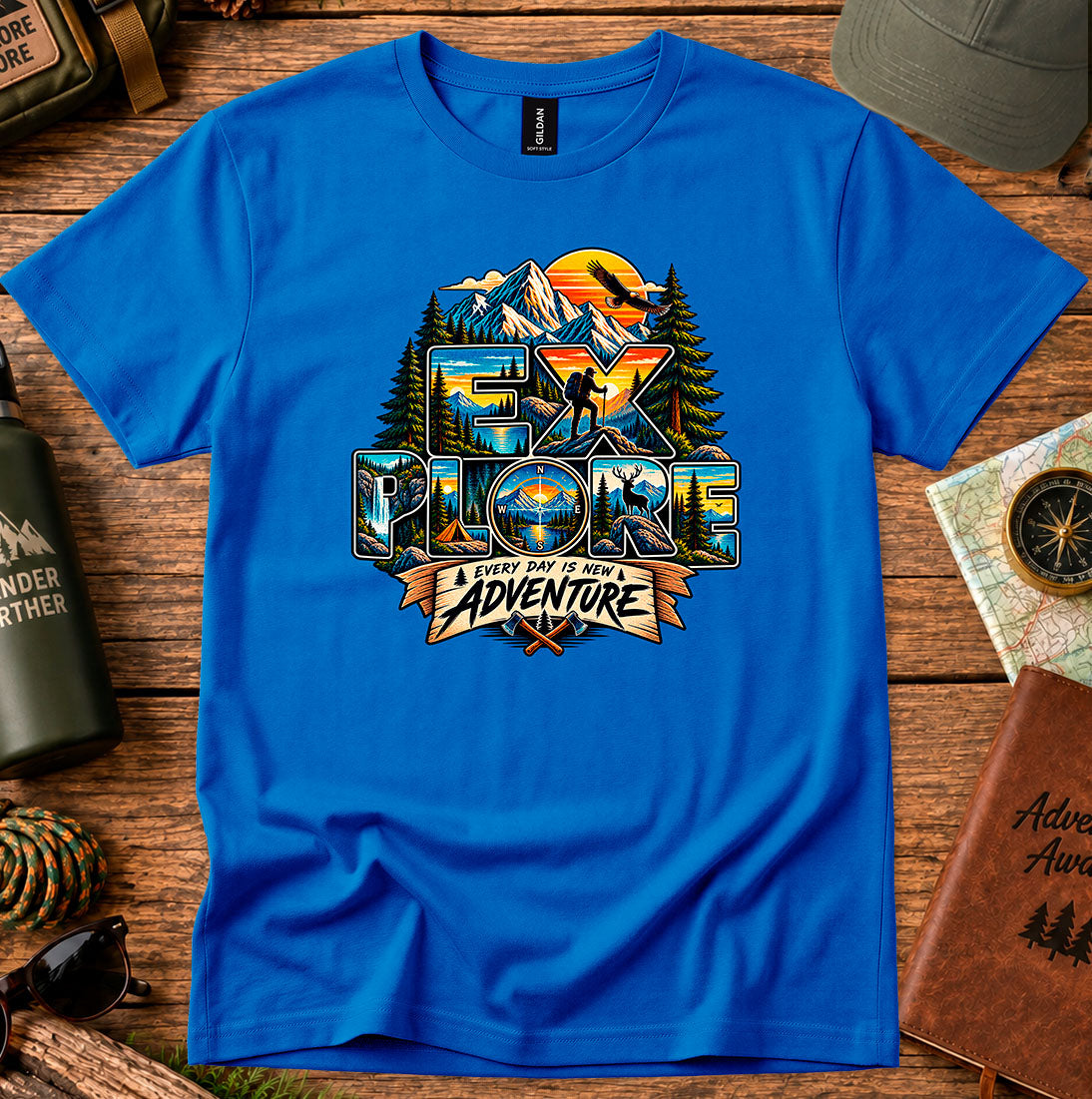 T-shirt featuring mountains, sunset colors and pine silhouettes inside bold lettering