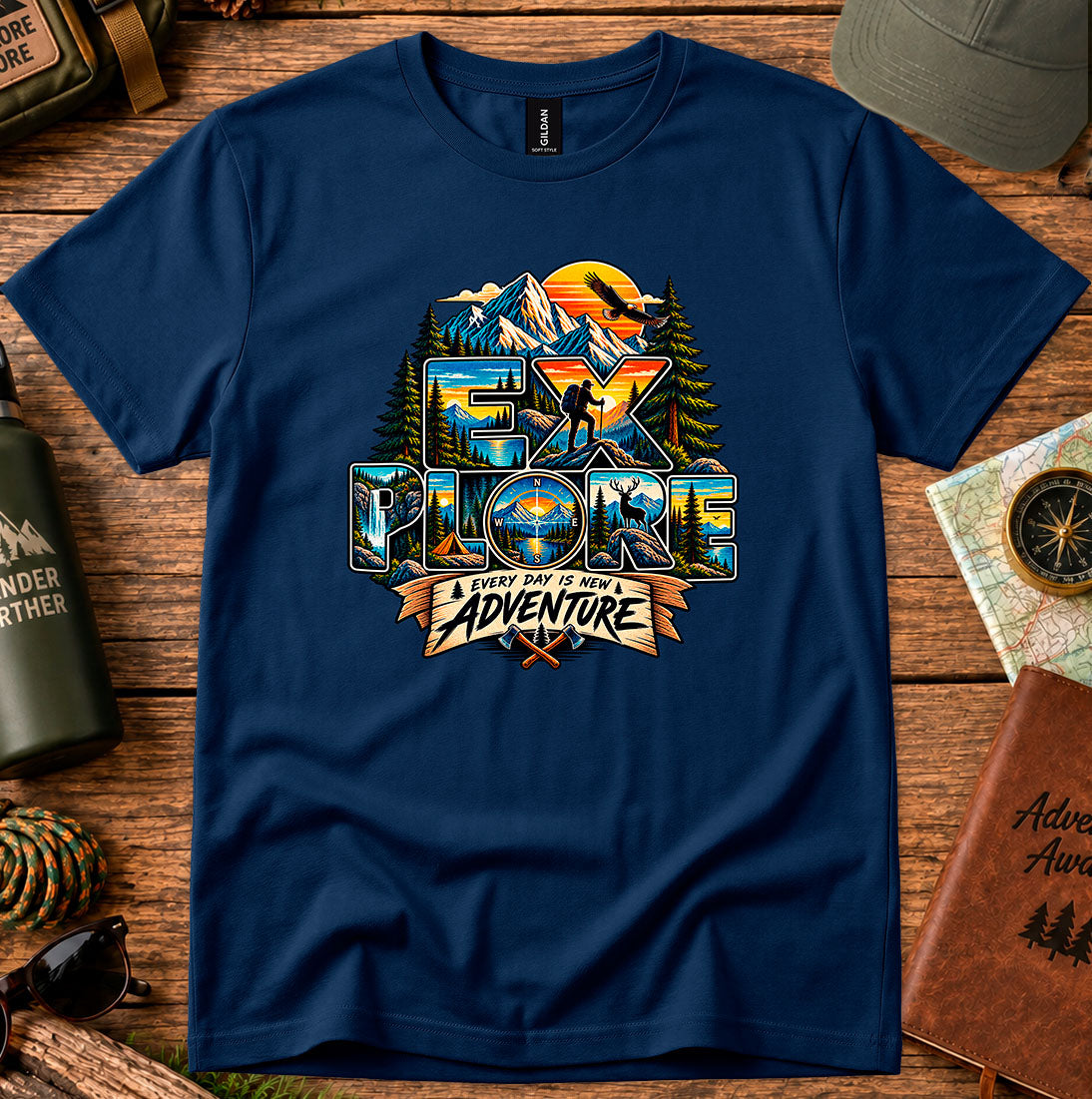 T-shirt featuring mountains, sunset colors and pine silhouettes inside bold lettering