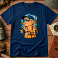 Navy T-shirt featuring a woman wearing a blue cap and sunglasses with mountain and lake scenery