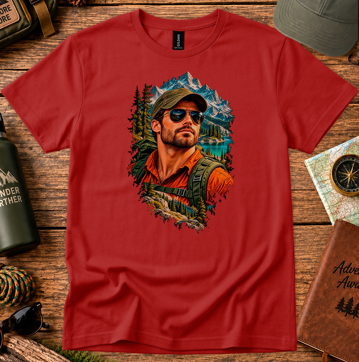 Red T-shirt featuring a bearded man in a cap and sunglasses framed by mountains and pine trees