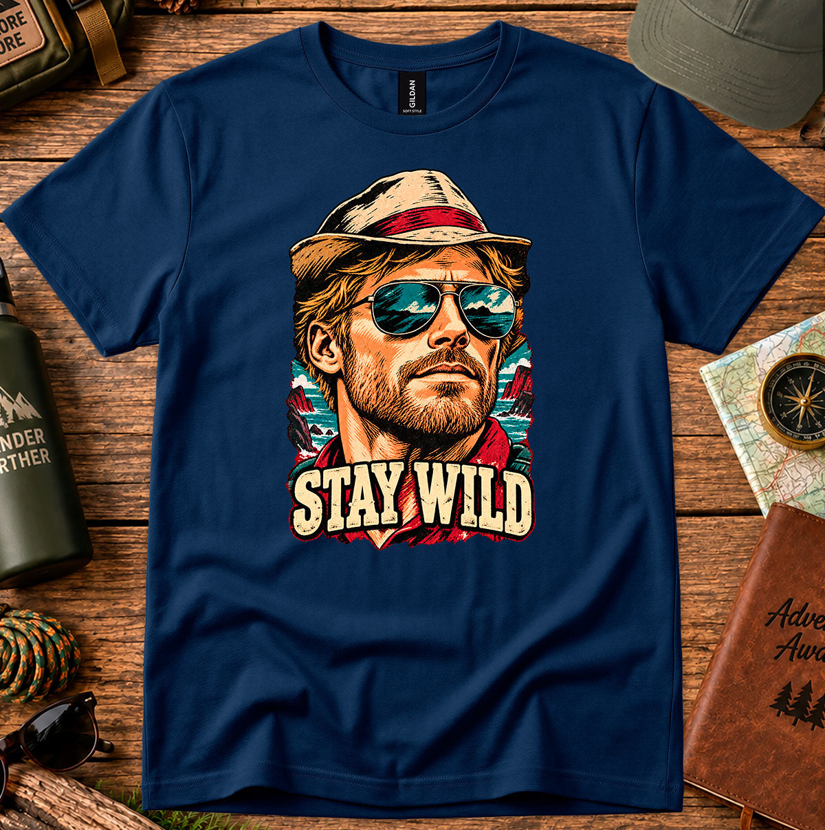 Navy T-shirt featuring a retro portrait of a man wearing a cap and sunglasses above STAY WILD lettering