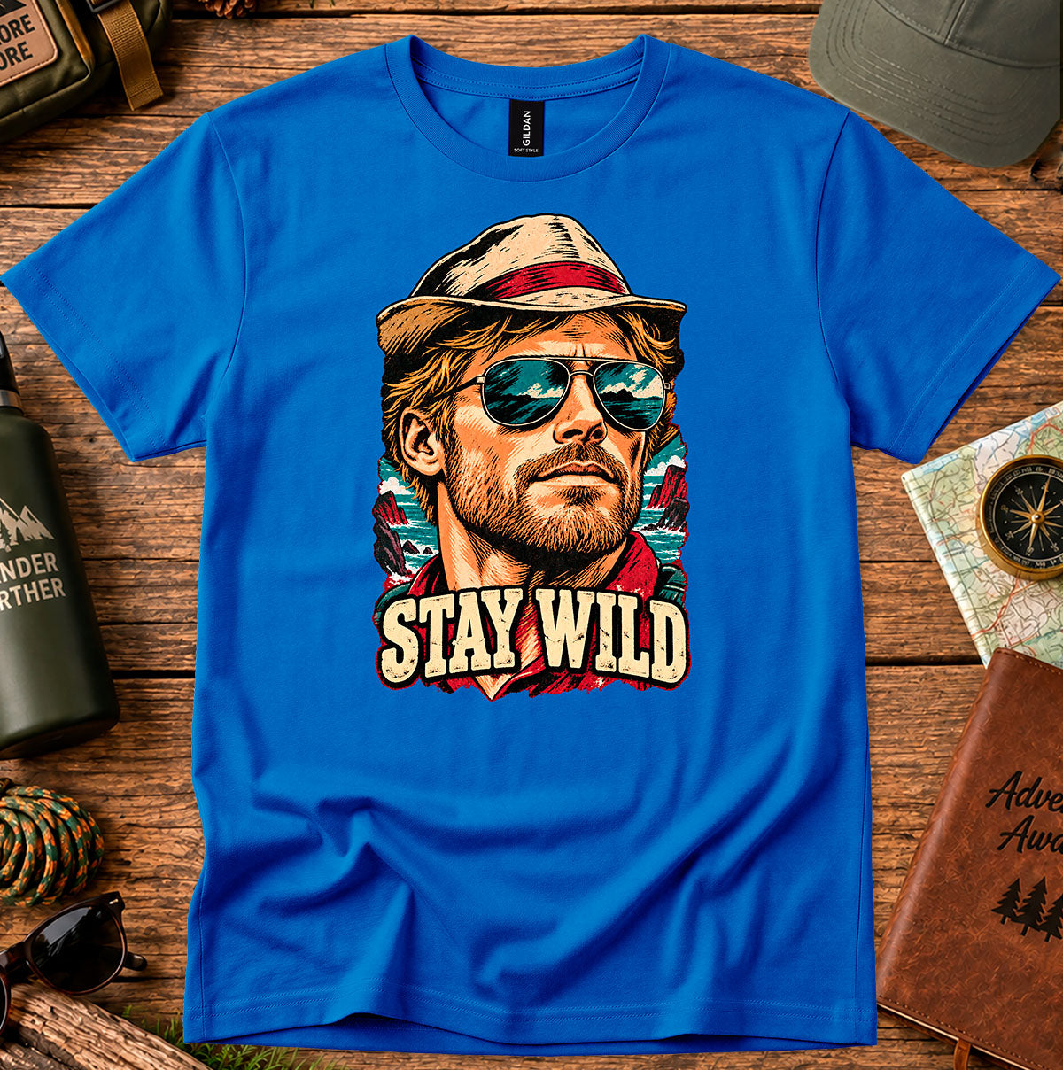 Royal blue T-shirt featuring a retro portrait of a man wearing a cap and sunglasses above STAY WILD lettering