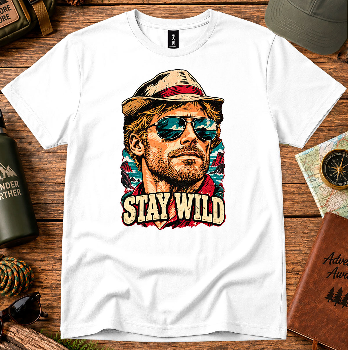 White T-shirt featuring a retro portrait of a man wearing a cap and sunglasses above STAY WILD lettering