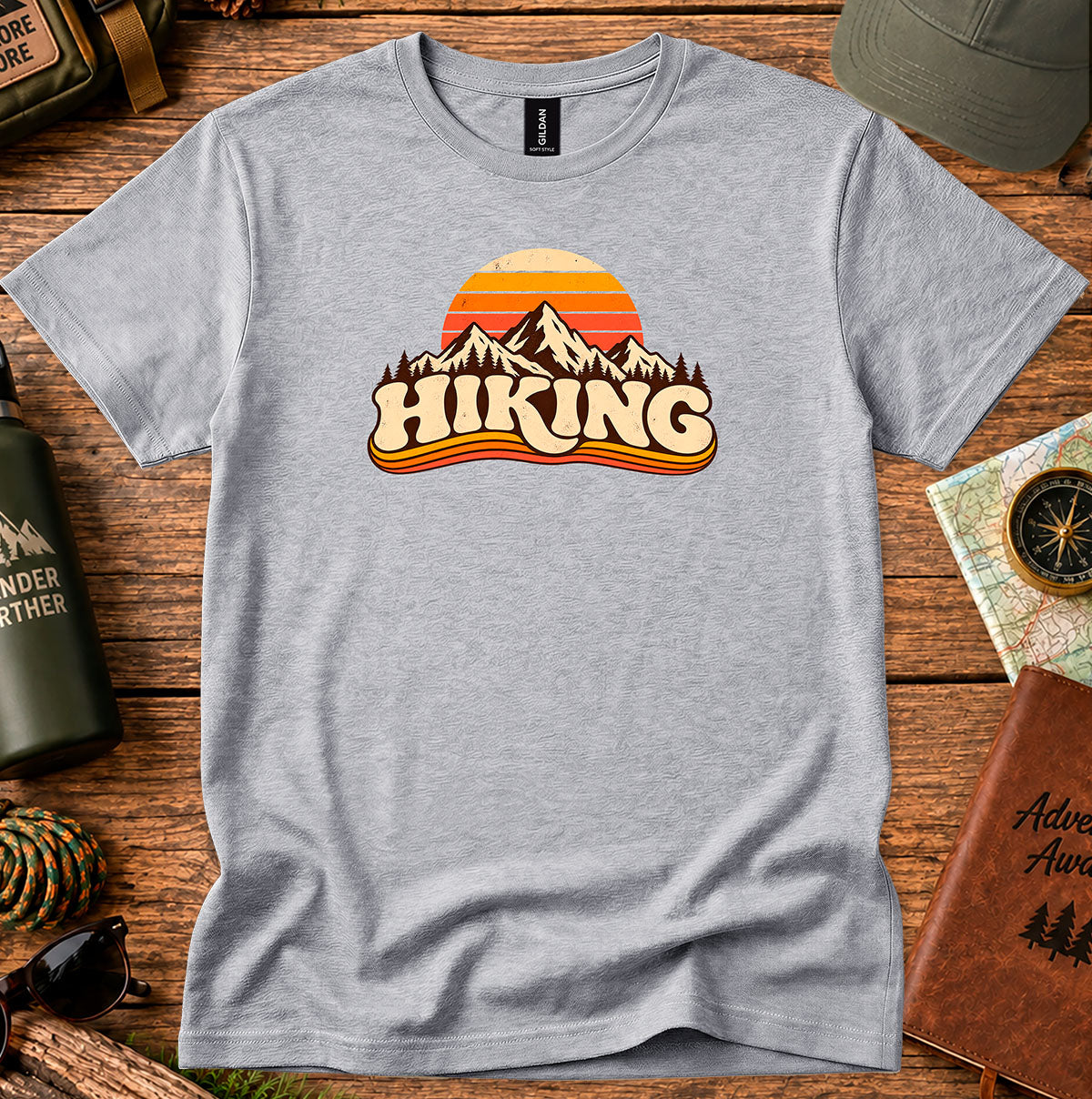 Grey T-shirt featuring a retro sunset and mountain graphic above HIKING lettering