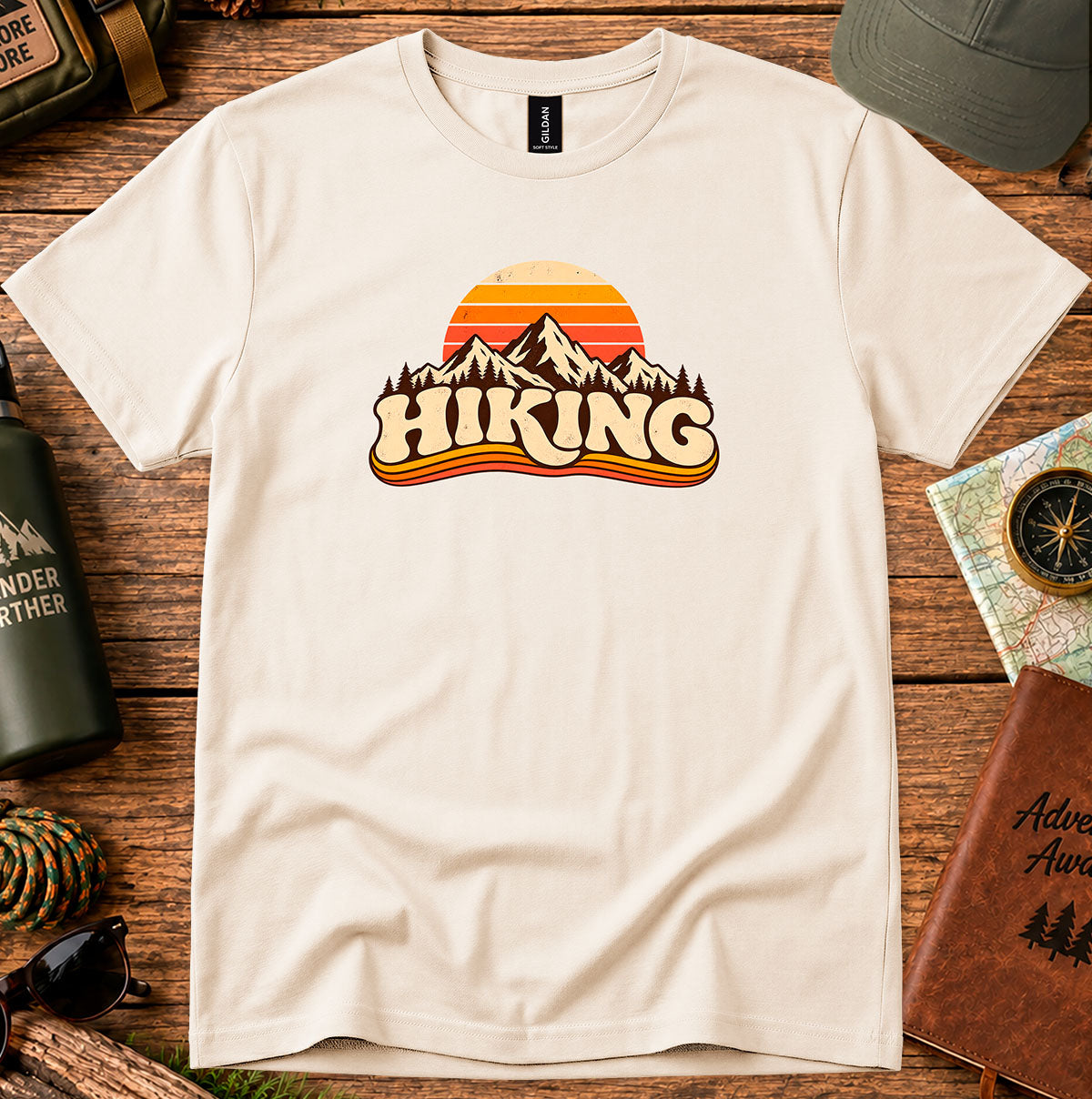 Cream T-shirt featuring a retro sunset and mountain graphic above HIKING lettering