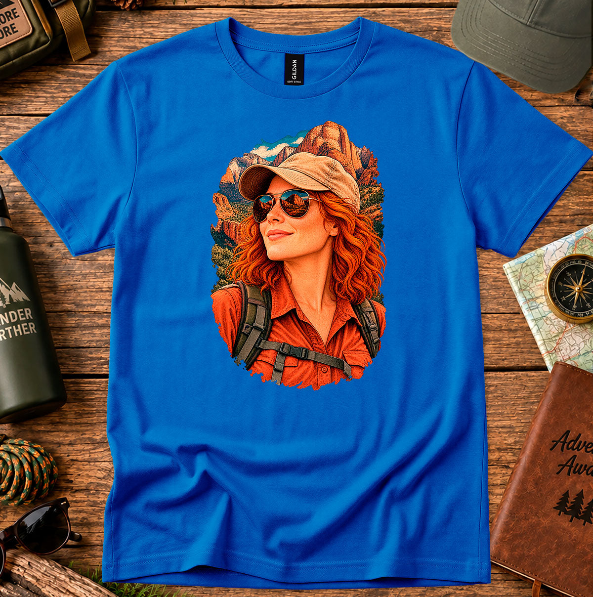 Royal blue T-shirt featuring a retro portrait of a woman wearing a cap, sunglasses and a red shirt