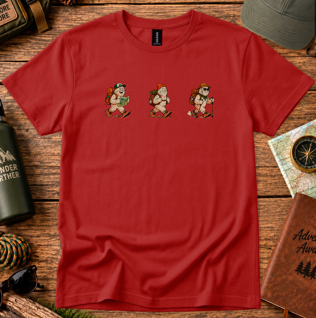 T-shirt featuring a playful trio of retro-style Bigfoot hikers