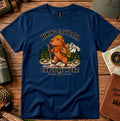 Navy T-shirt featuring a capybara wearing a backpack and bandana, framed by pine trees and mountains