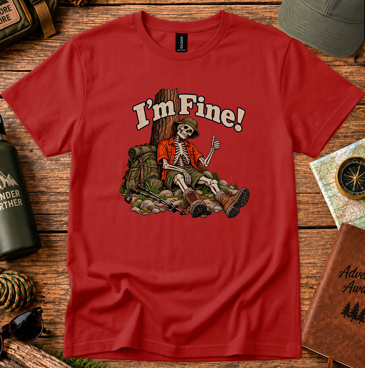 I'm Fine graphic T-shirt with a skeleton hiker giving a thumbs-up beside a tree, backpack and trekking poles