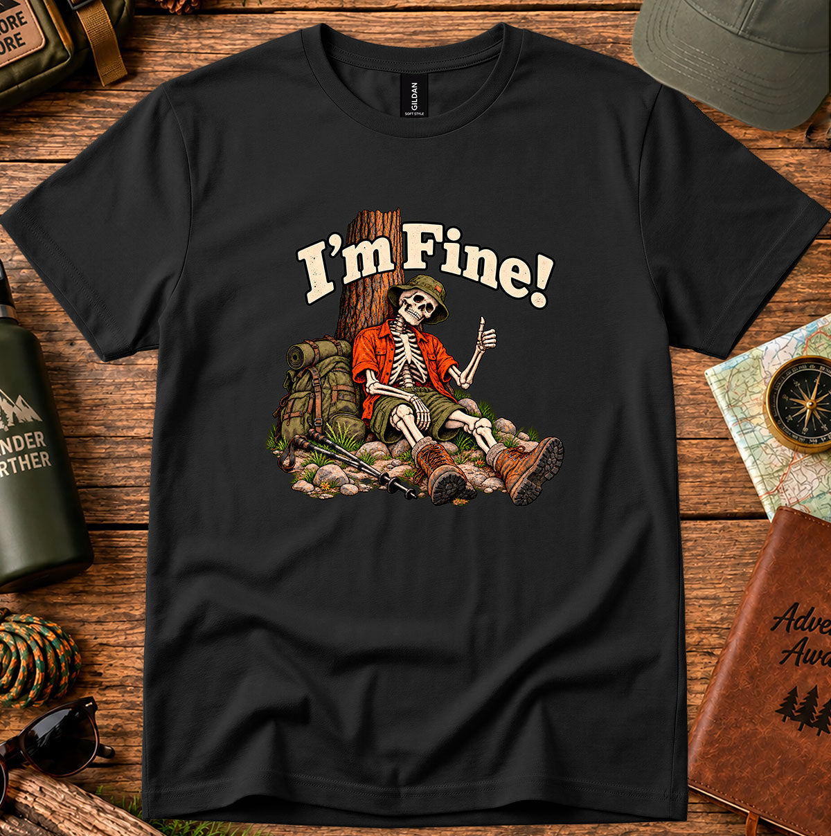 I'm Fine graphic T-shirt with a skeleton hiker giving a thumbs-up beside a tree, backpack and trekking poles