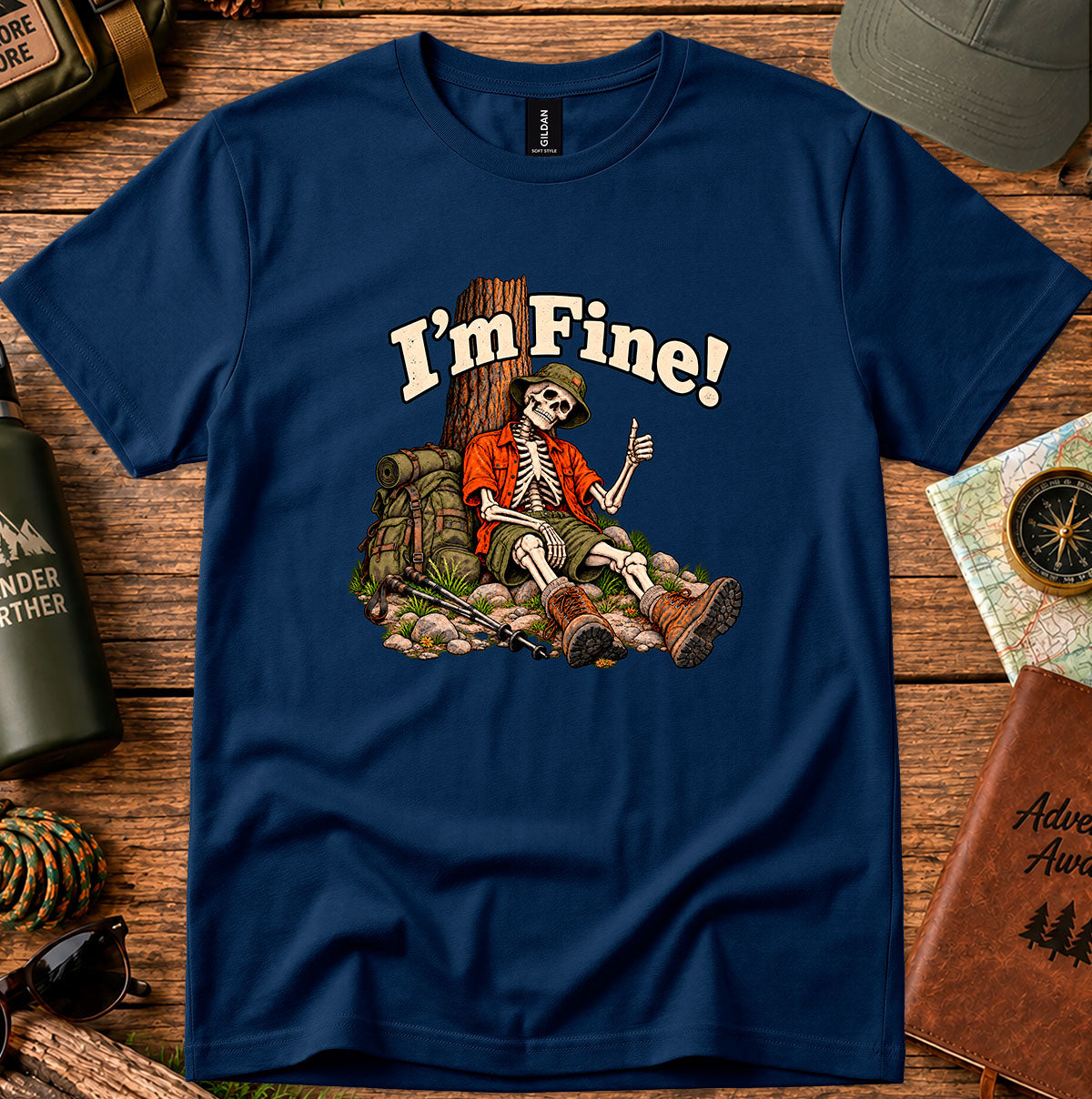 I'm Fine graphic T-shirt with a skeleton hiker giving a thumbs-up beside a tree, backpack and trekking poles