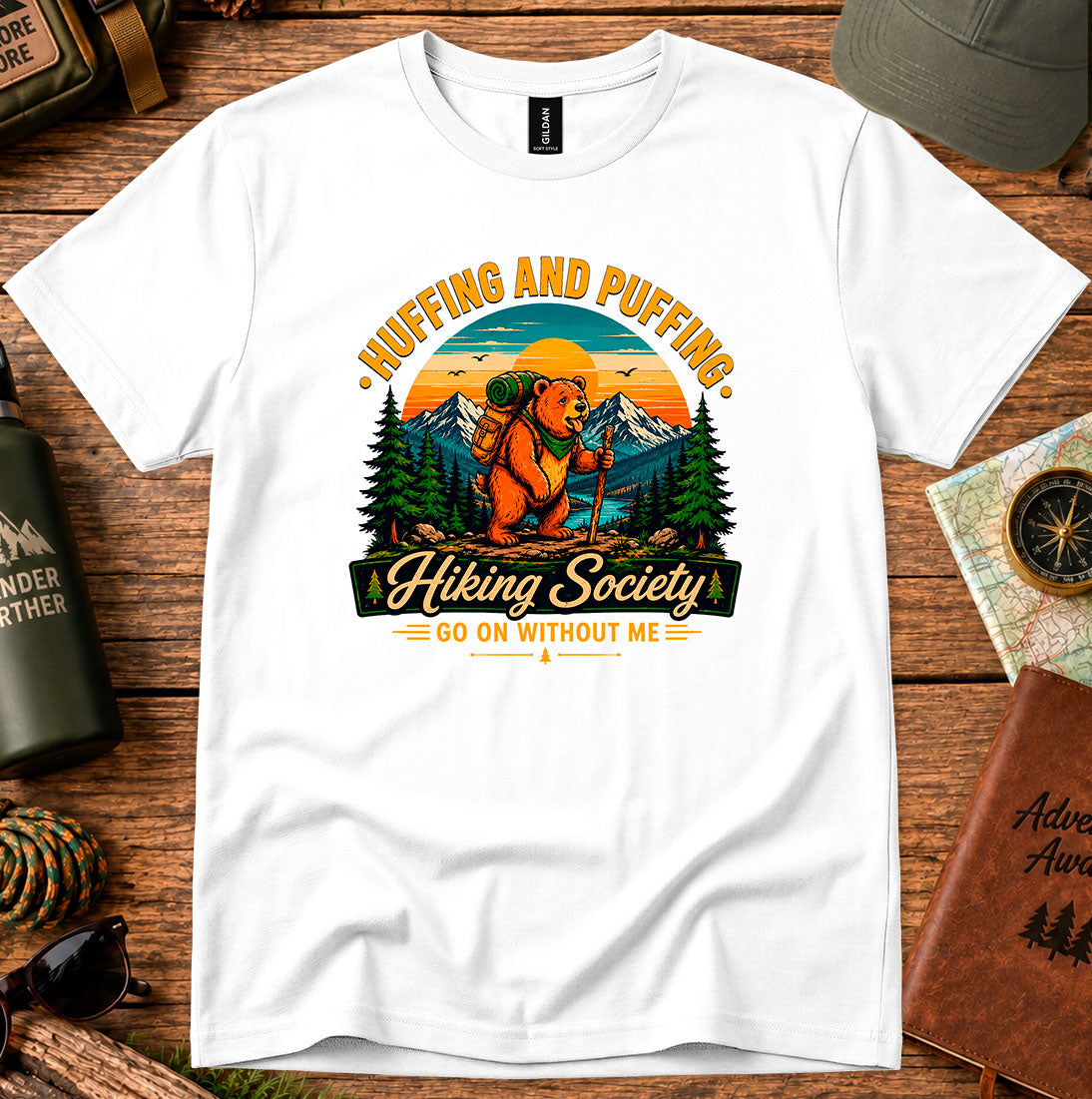 T-shirt featuring a humorous mountain hiker graphic with pine trees