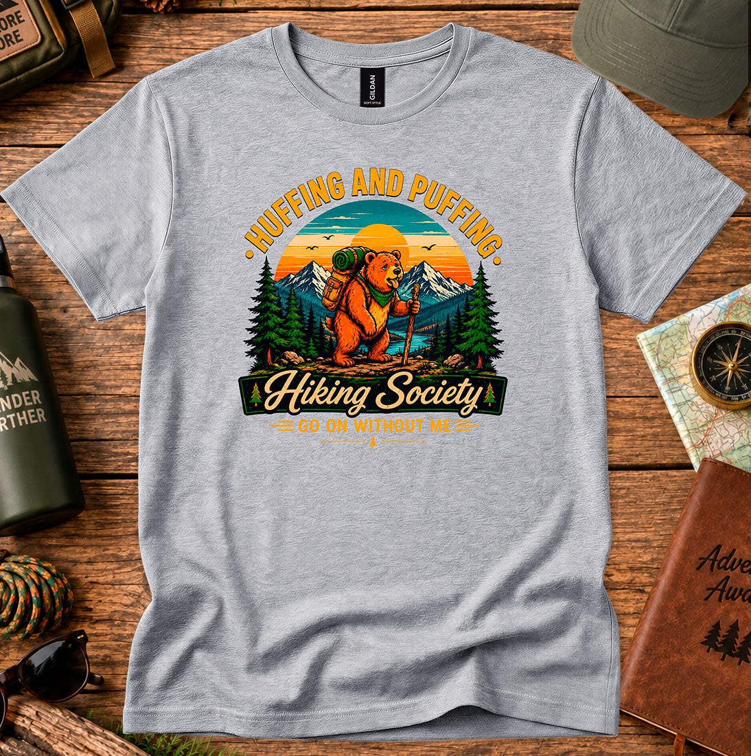 T-shirt featuring a humorous mountain hiker graphic with pine trees