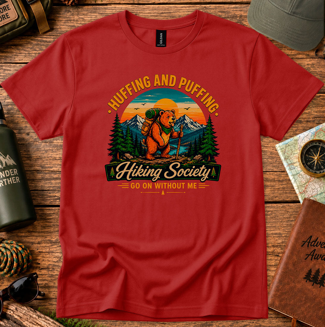 T-shirt featuring a humorous mountain hiker graphic with pine trees