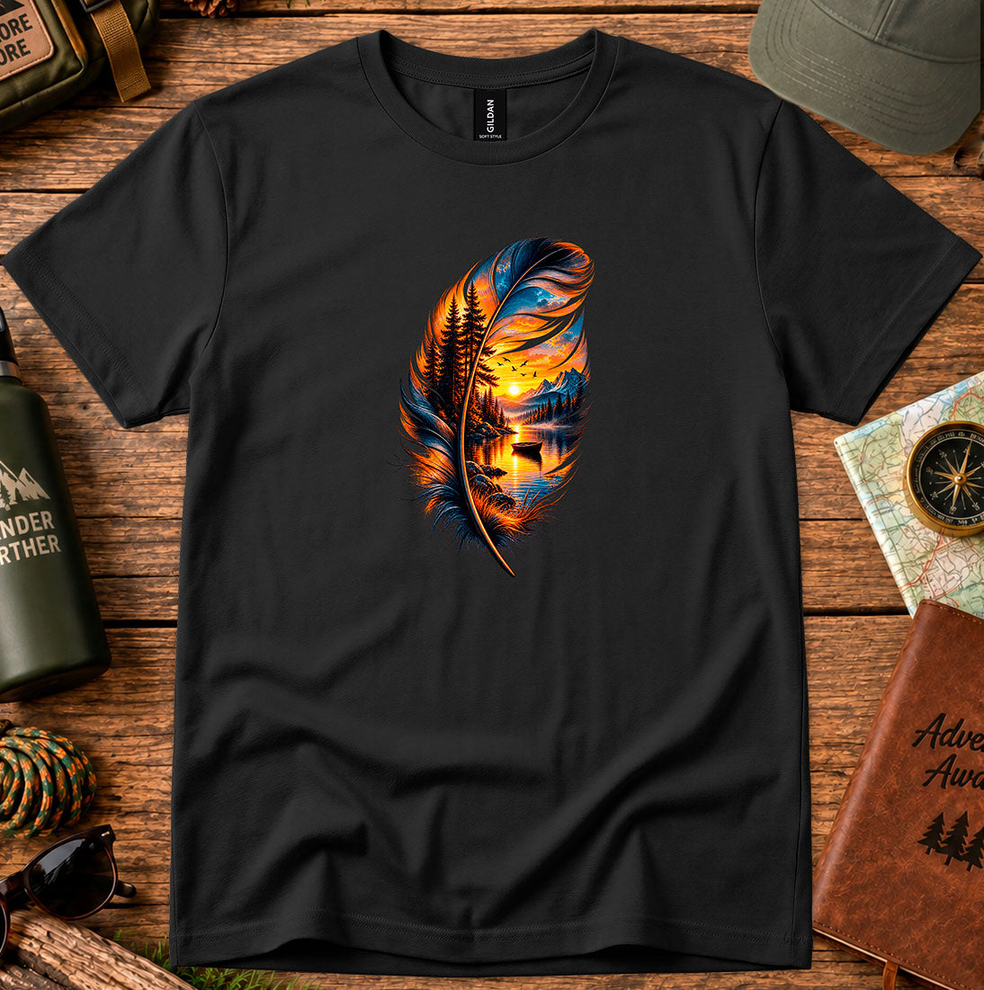 T-shirt featuring a hand-painted feather containing a lakeside sunset