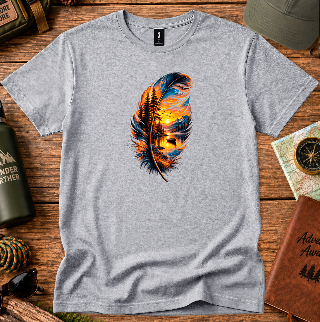 T-shirt featuring a hand-painted feather containing a lakeside sunset