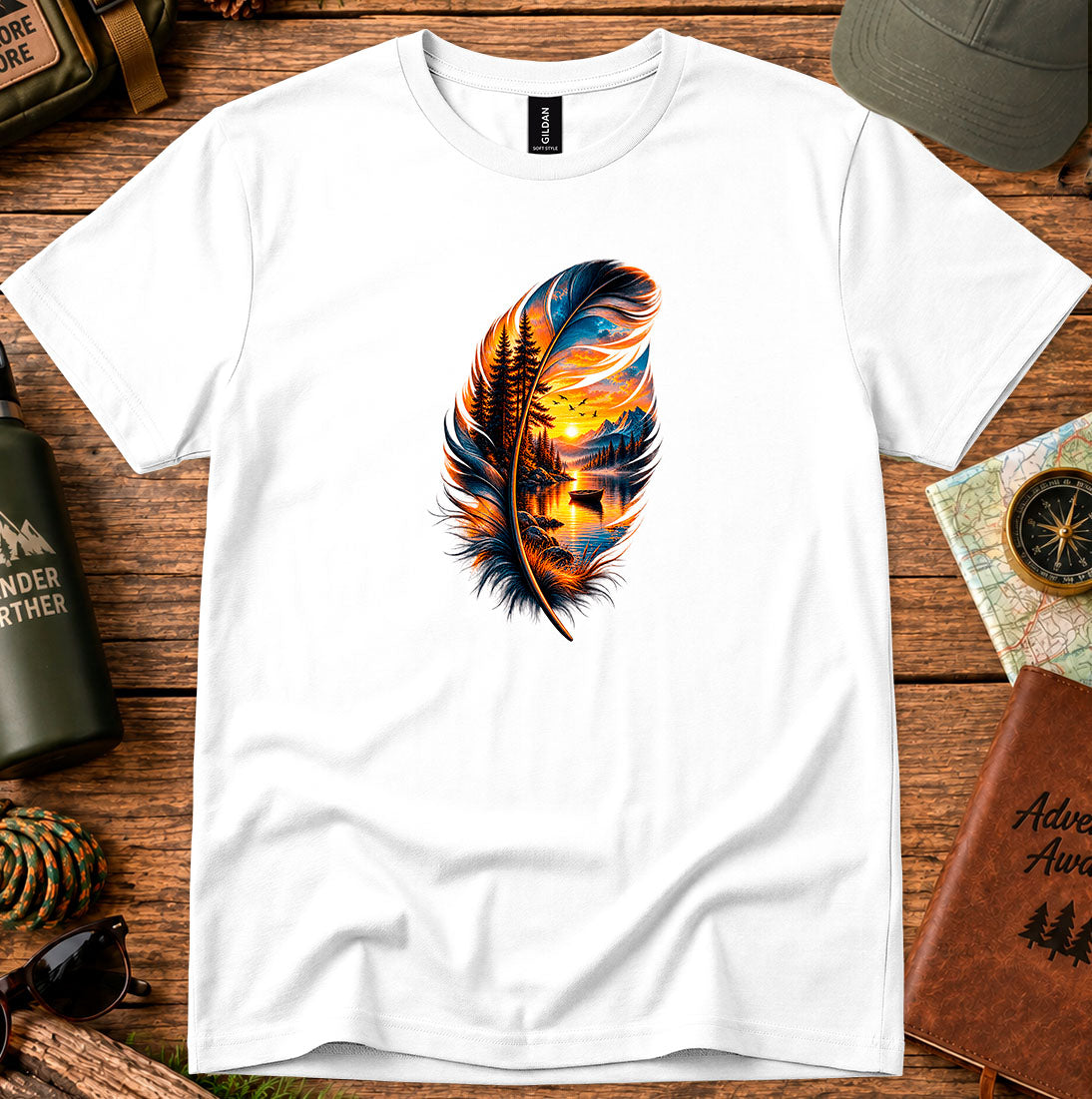 T-shirt featuring a hand-painted feather containing a lakeside sunset