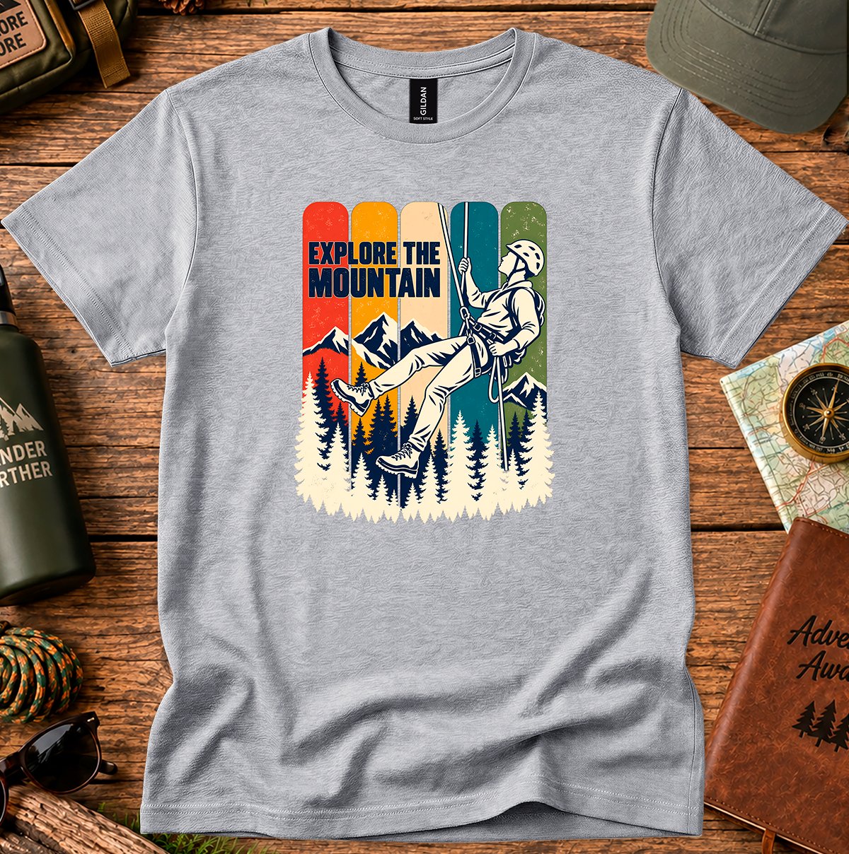 Explore the Mountain graphic T-shirt with a rope climber, mountain peaks and pine trees
