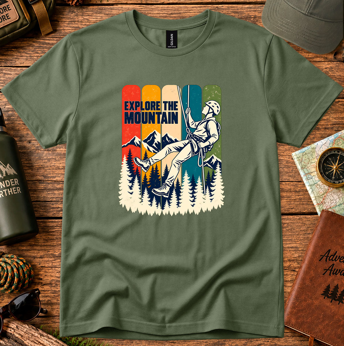 Explore the Mountain graphic T-shirt with a rope climber, mountain peaks and pine trees