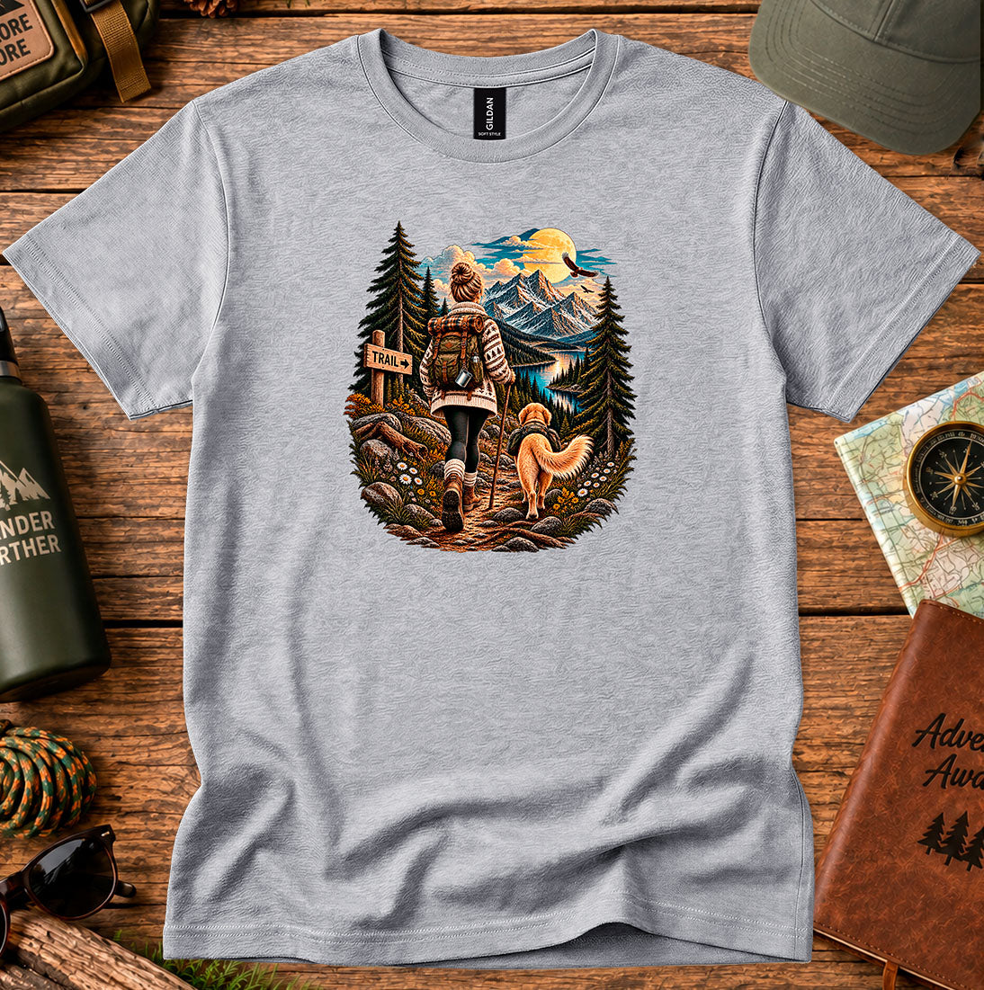 T-shirt featuring a hiker at a trail sign overlooking a mountain valley