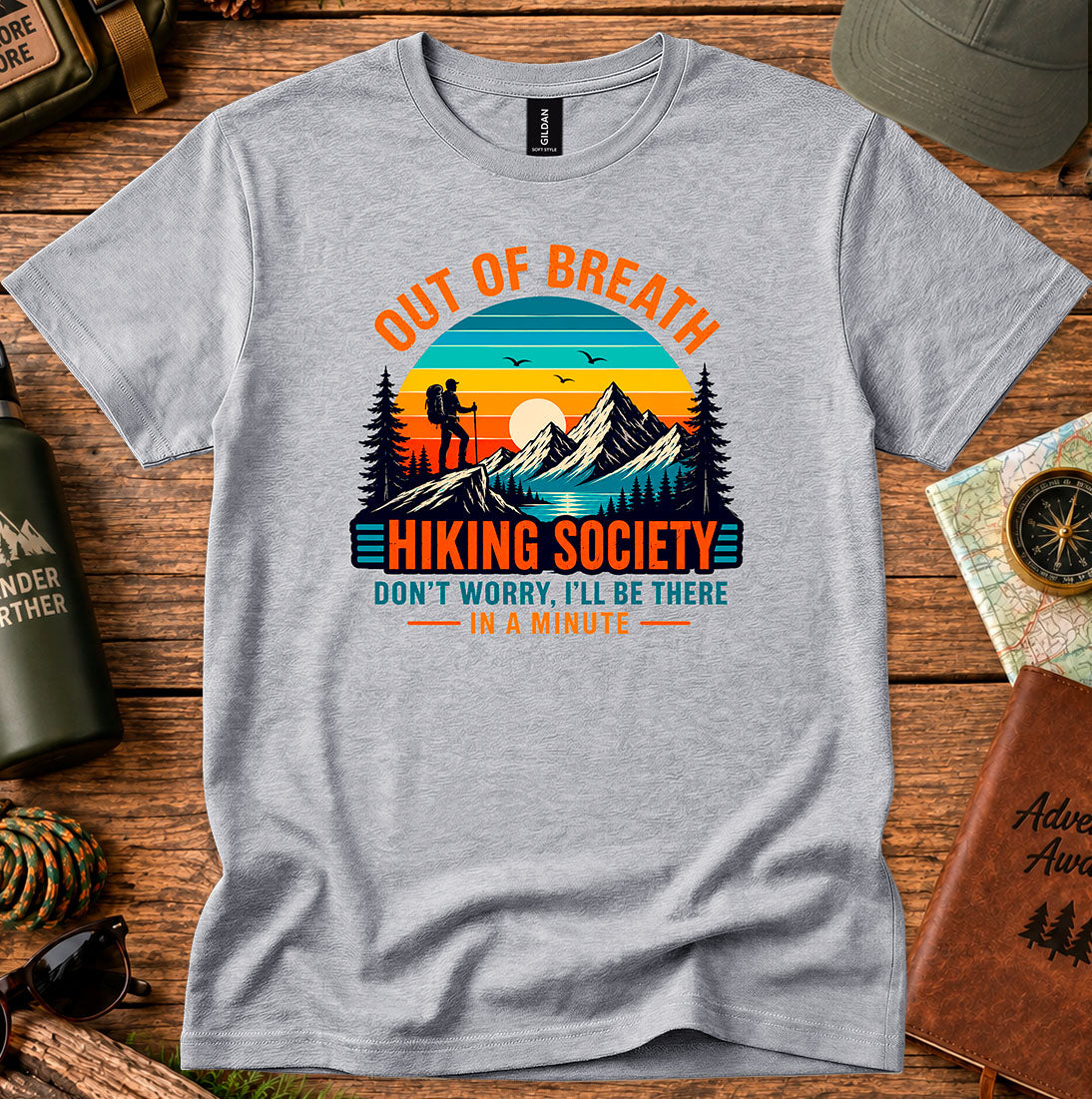 T-shirt featuring hikers on a sunlit ridge with Out of Breath lettering