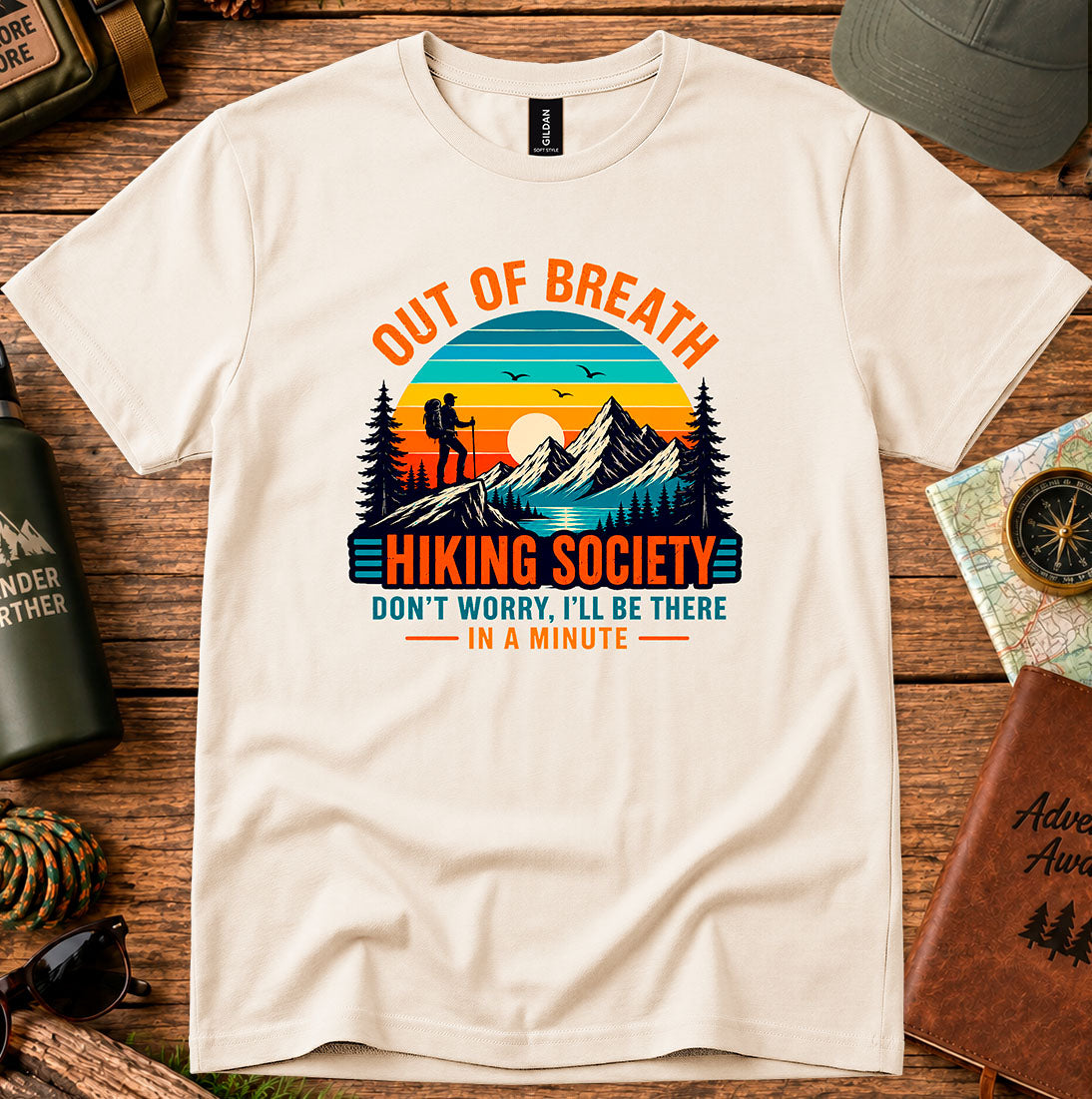 T-shirt featuring hikers on a sunlit ridge with Out of Breath lettering
