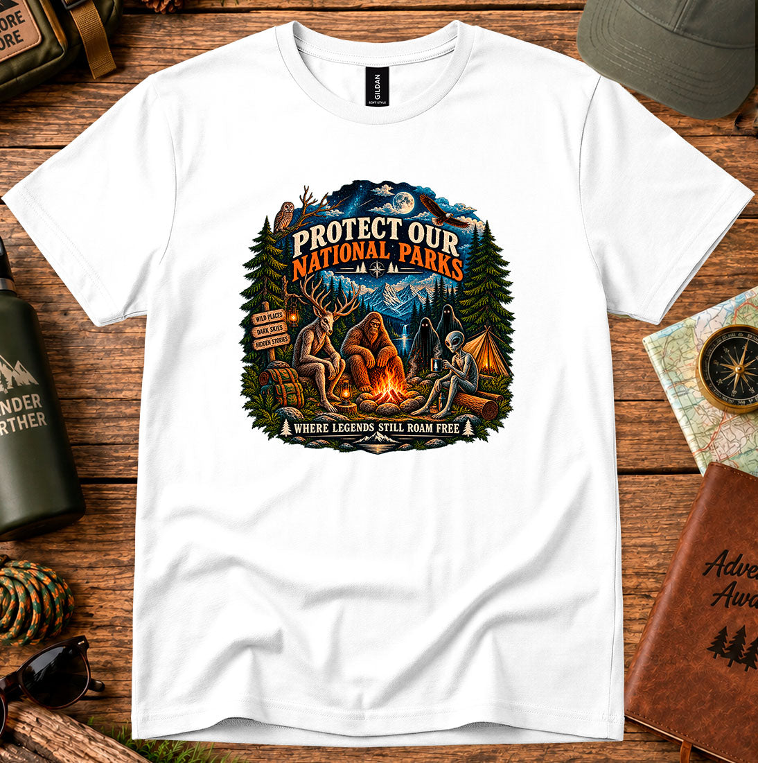T-shirt featuring pine trees and a campfire with Protect Our National Parks lettering