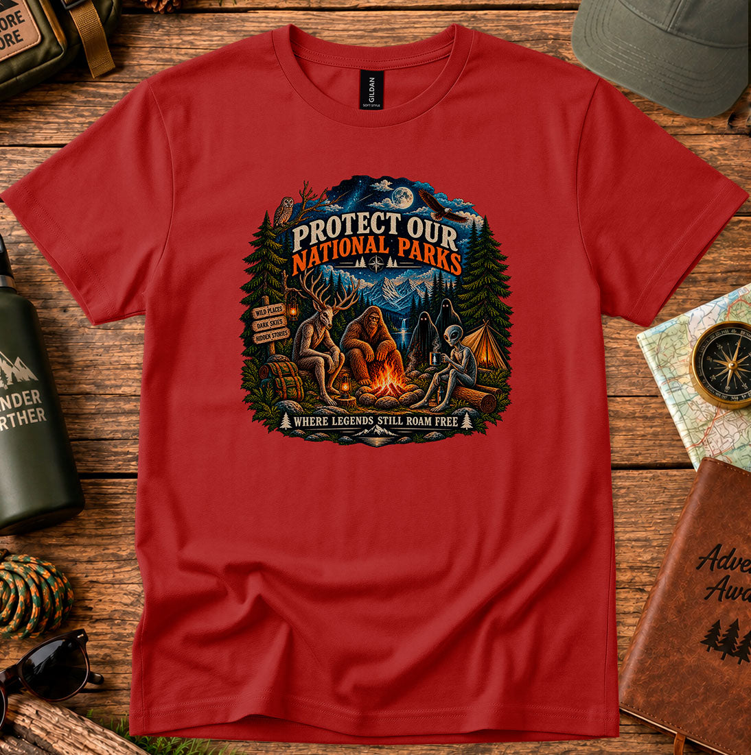T-shirt featuring pine trees and a campfire with Protect Our National Parks lettering