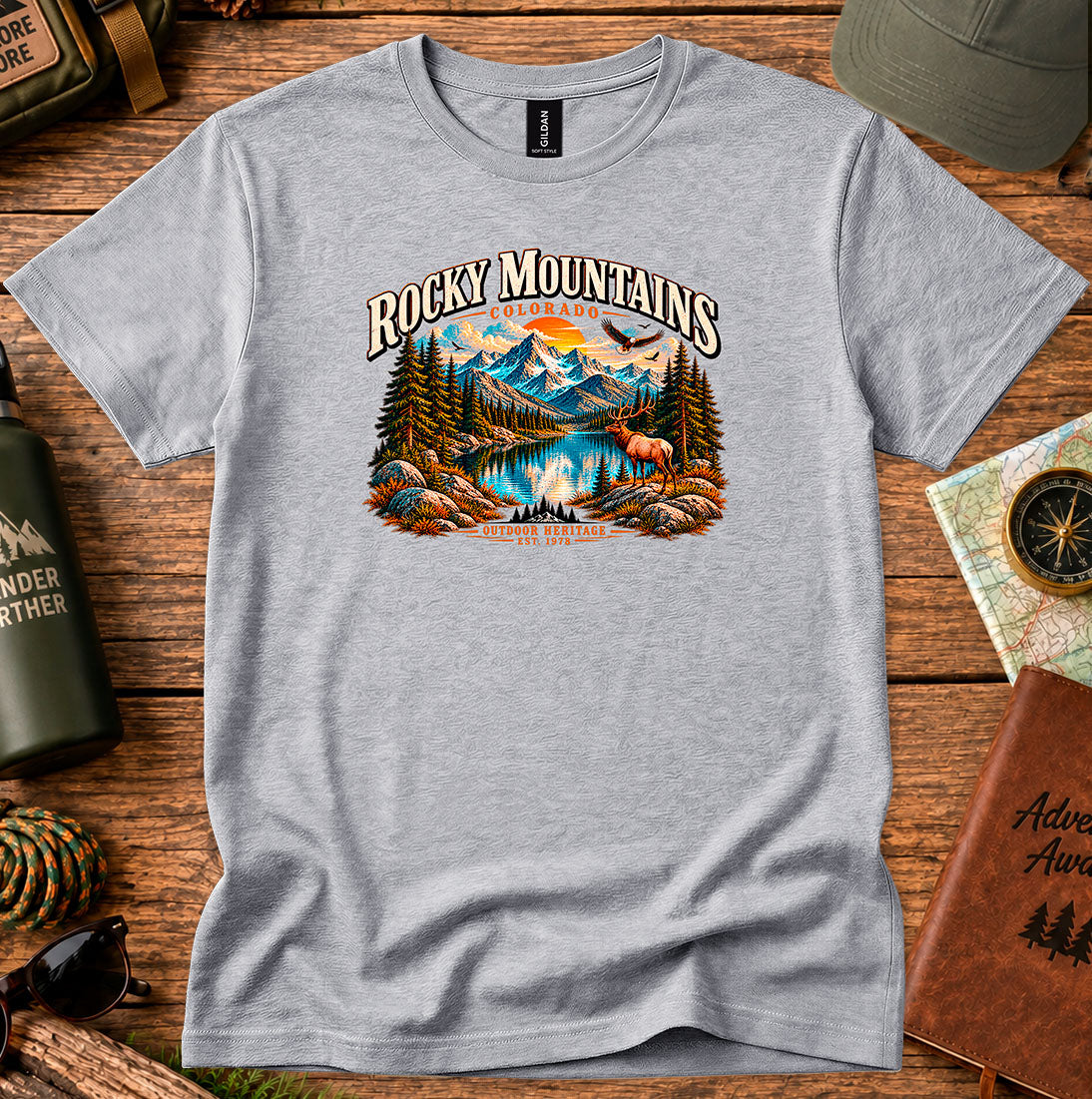 T-shirt featuring Rocky Mountain peaks, pine forests and an elk by an alpine lake