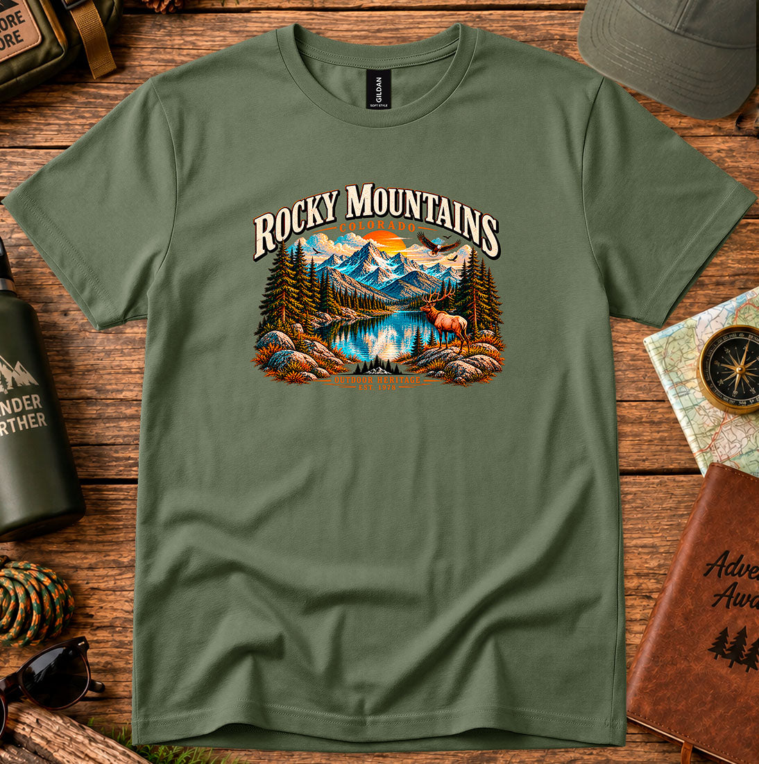 T-shirt featuring Rocky Mountain peaks, pine forests and an elk by an alpine lake