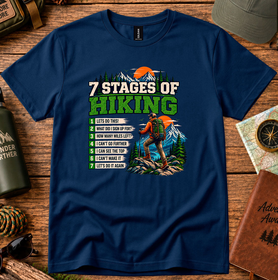 T-shirt featuring a Stages of Hiking checklist with a hiker and sunset