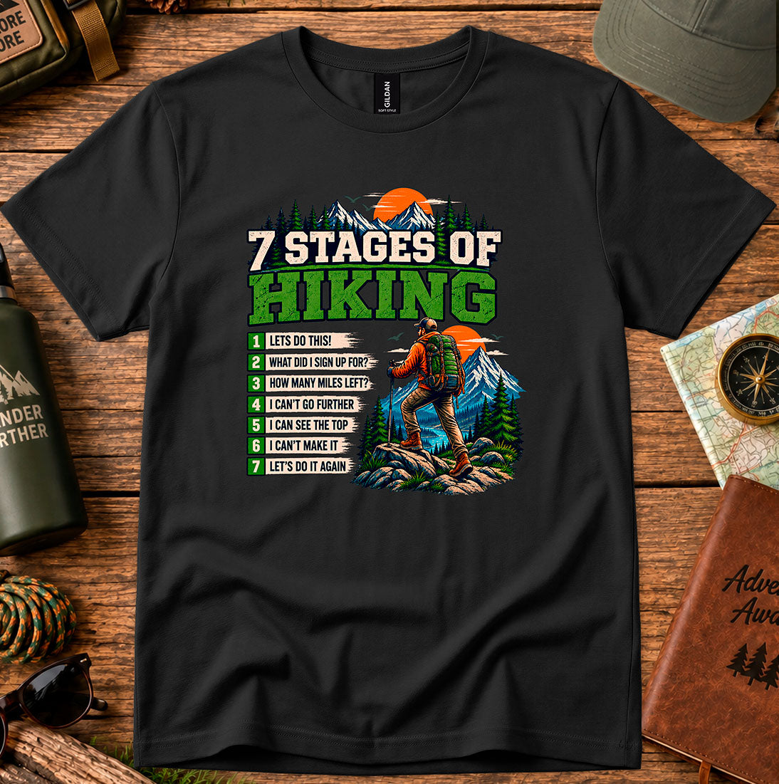 T-shirt featuring a Stages of Hiking checklist with a hiker and sunset