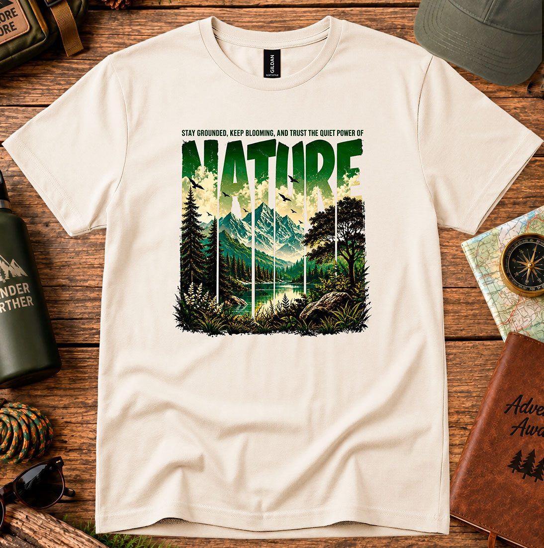 T-shirt featuring a layered landscape of pine trees and distant mountains