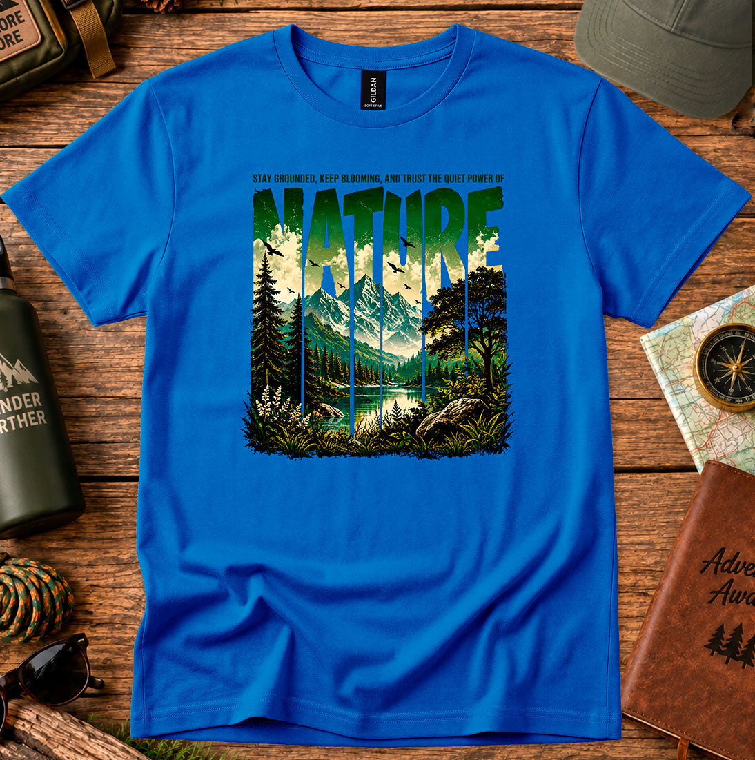 T-shirt featuring a layered landscape of pine trees and distant mountains
