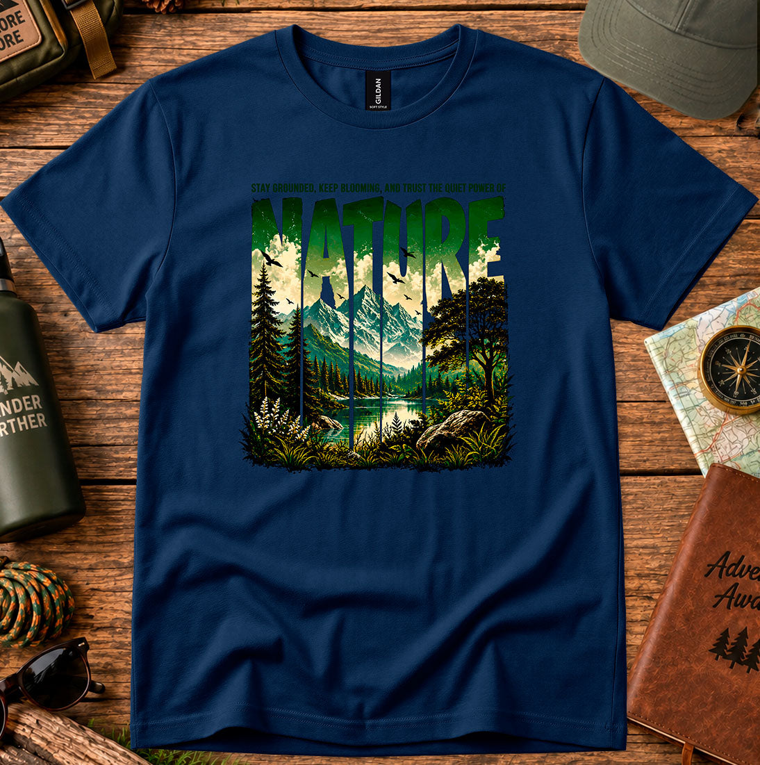 T-shirt featuring a layered landscape of pine trees and distant mountains
