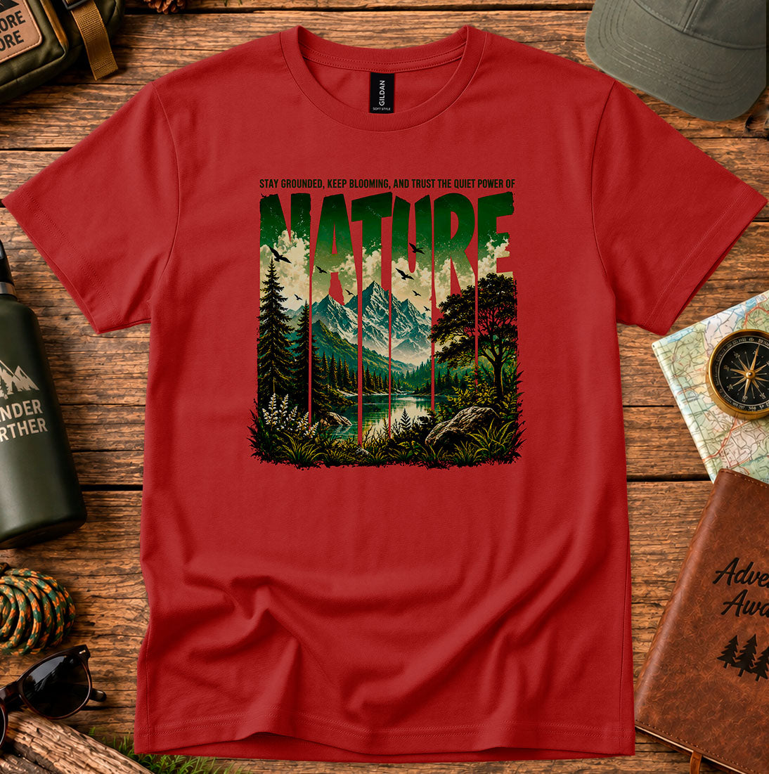 T-shirt featuring a layered landscape of pine trees and distant mountains