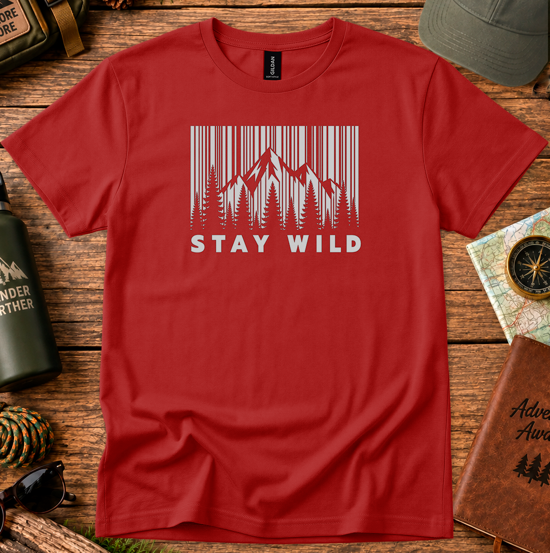 T-shirt featuring a monochrome mountain and pine tree design with Stay Wild lettering