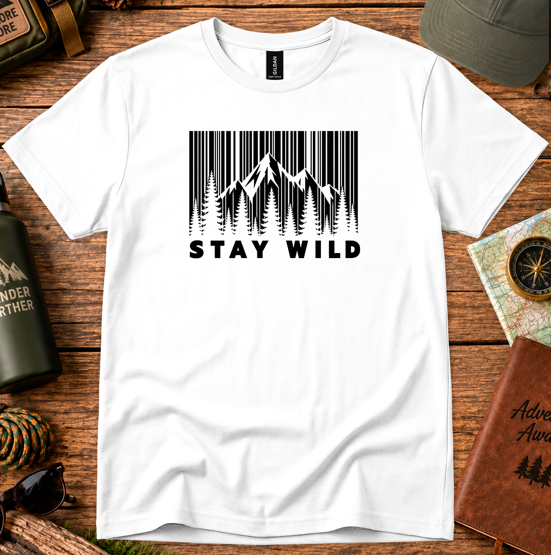 T-shirt featuring a barcode-style forest and mountain graphic with Stay Wild lettering