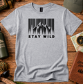 T-shirt featuring a barcode-style forest and mountain graphic with Stay Wild lettering